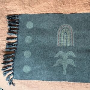 Hand-dyed and embroidered indigo rug by Brass Arrow